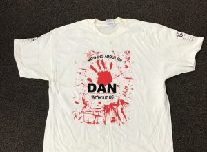   T-shirt: Nothing About Us Without Us – DAN