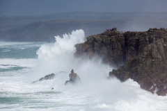 Huge waves crashing into cliffs at Senne Cove photographed from Lands End Cornwall England UK