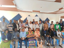 Group photo of about 30 people in Rwanda, both men and women, including wheelchair users.