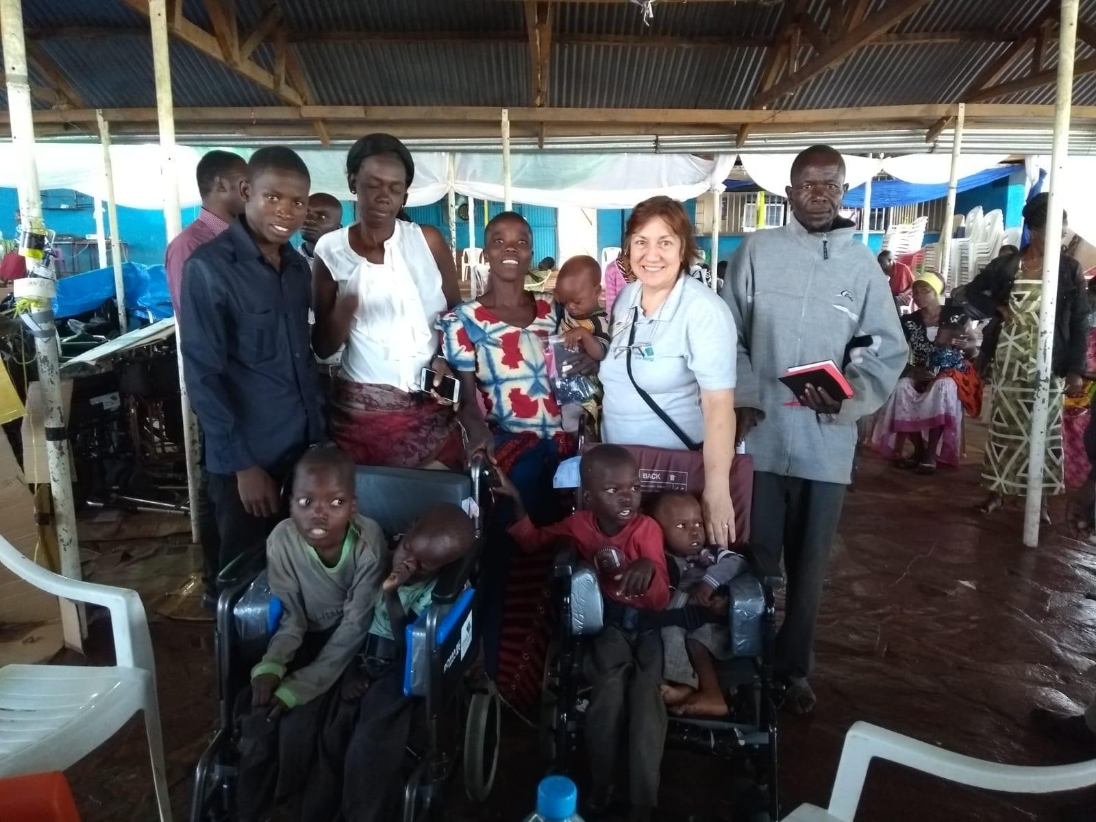 A family gathered together with one of the Wheels team