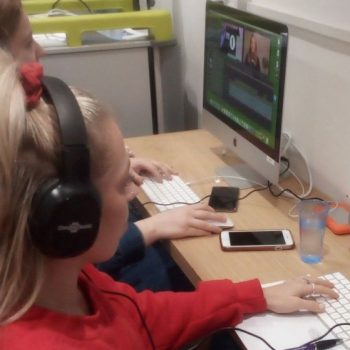 Children in a media studio at a computer