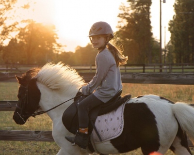 Young girl riding her  pony