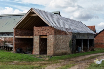 An old barn building that is currently being renovated and converted.