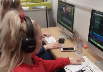 Children in a media studio at a computer