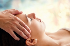 Therapist massaging woman’s head.