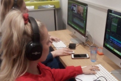 Children in a media studio at a computer
