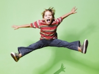 Boy jumping on green background